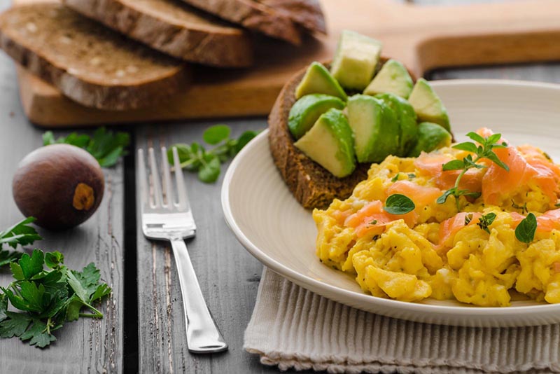 Bread with avocado and scrambled eggs.
