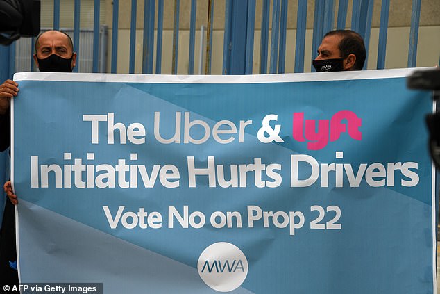 Both Uber and Lyft have pledged to spend more than a hundred million dollars to support a November ballot measure, Proposition 22, that would exempt them from AB5. Pictured: Drivers protest the proposition on August 6 in Los Angeles
