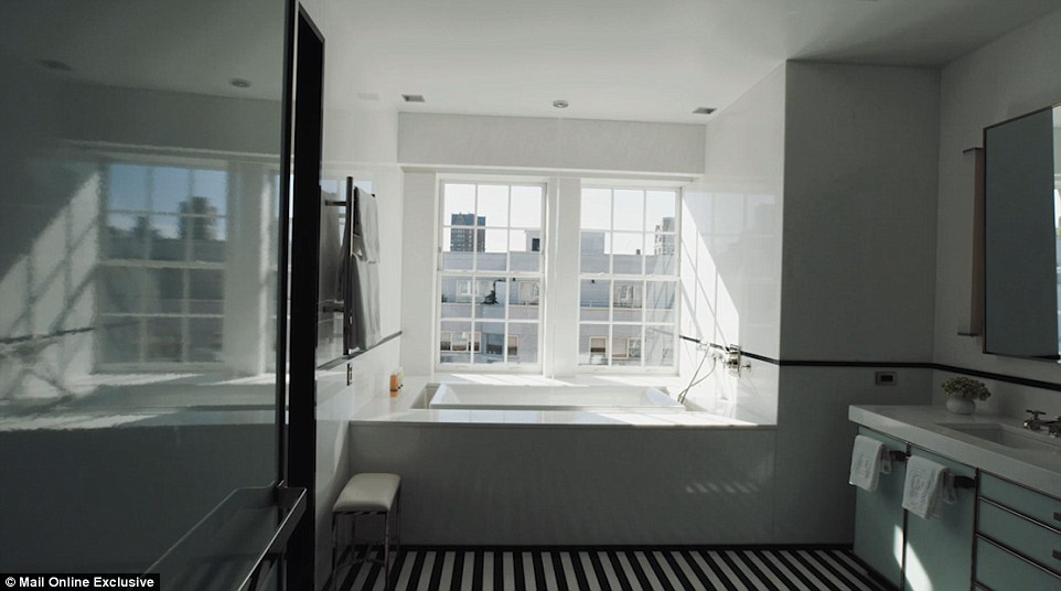 One of the bathrooms has a lookout over the rooftops beyond with a large square-shaped tub placed in front of the window. A video that takes viewers on a walk through the suite shows that bizarrely, the bathtub is filled by water cascading from a spout in the ceiling