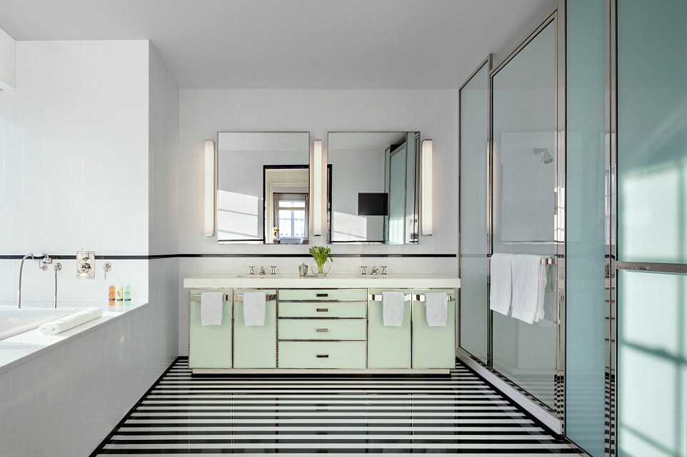The master bathroom features double washbasins and a snazzy black-and-white stripped floor