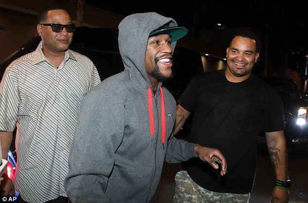Walking free: Floyd Mayweather (centre) is greeted by friends and family as he left the Clark County Detention Centre early this morning