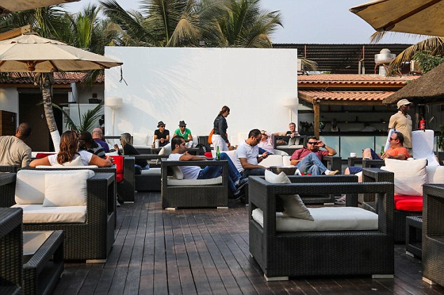 Cash rich: Expats at the Tamariz Beach Club. Offices and accommodation are in short supply and the expats are overloading the city with their demands