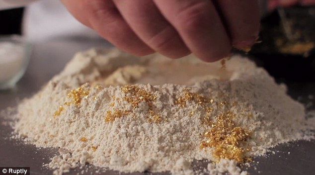 Baker and bakery co-owner Juan Manuel adding gold to flour to make the bread mix