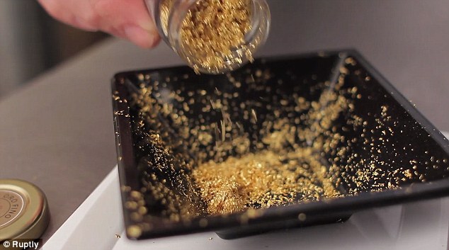 A jar of gold is emptied onto baking tray ready to be mixed in with flour and sprinkled on top