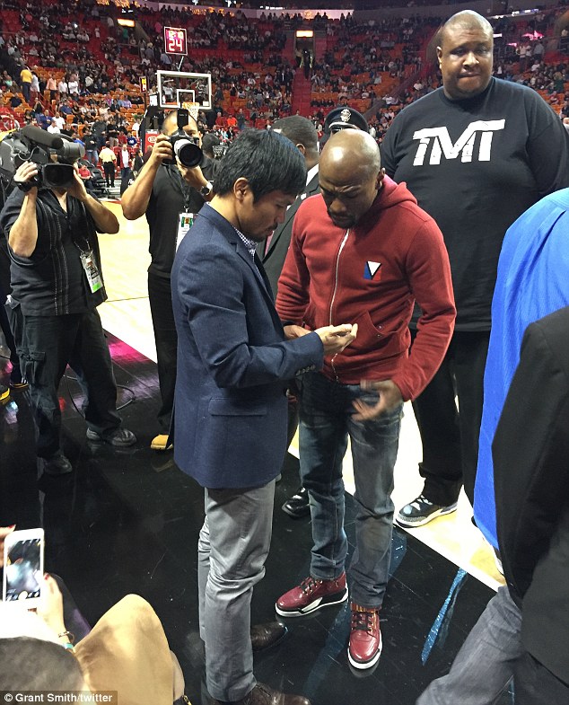 A huge bodyguard can be seen keeping a close eye on events at the American Airlines Arena