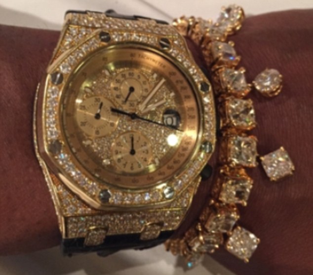 Mayweather shows off a gold watch and some sparkly jewels in this picture