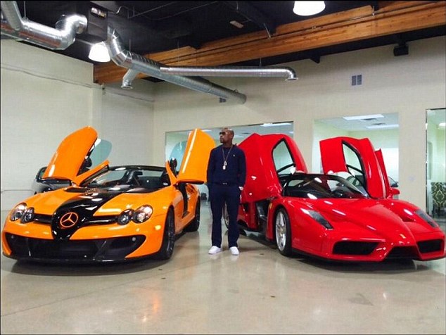 Mayweather with just two of his luxury cars which he collects like few others
