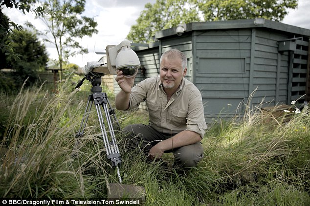 Modern Times: The Great British Garden Watch. Jason with one of the 30 cameras he has set up in his garden