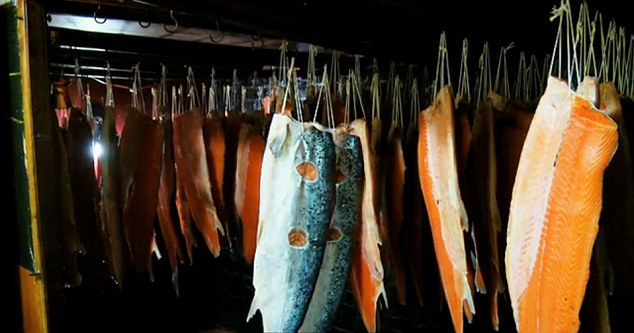 Fish hung up in what looks more like a celebrity wardrobe or a Dali painting than a storage fridge
