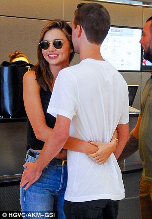 Loved up: Miranda Kerr put on an affectionate display with boyfriend Evan Spiegel as they arrived at LAX Airport on Wednesday