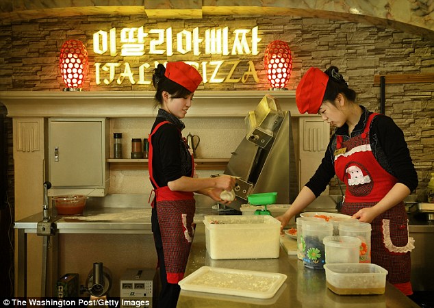 Korean women make pizzas at upscale italian pizza restaurant on Mirae Scientists Street in Pyongyang, North Korea