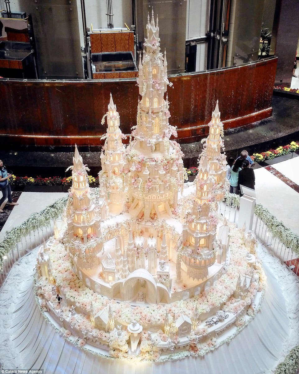 This extravagant castle cake has real working lights in all the windows which makes it look as if the mini bride and groom are really living in this edible fairytale world