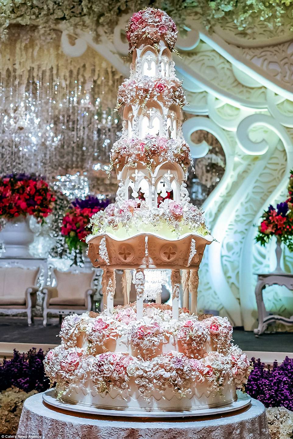 This church tower cake is held up by intricate pillars and it even features a mini chandelier that really lights up