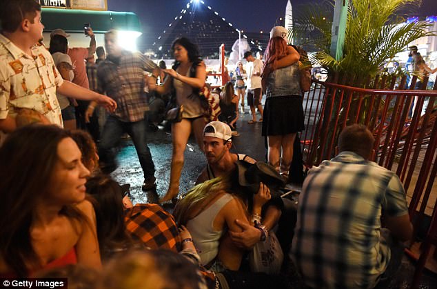 58 people were slaughtered and another 527 were injured in the massacre. Pictured, festival-goers, crouch in cover at the Route 91 Harvest country music festival after gunfire rained down on crowds