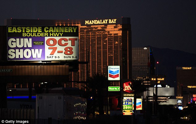 With the Mandalay Bay Resort and Casino in the background, a billboard advertising an upcoming gun show is seen along the Las Vegas Strip