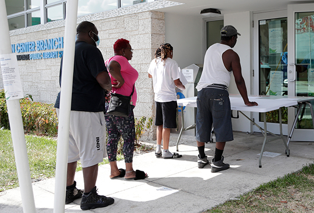 Люди ожидают помощи в получении пособий по безработице в Майами