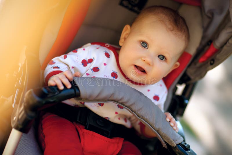 Baby in sitting stroller stock images