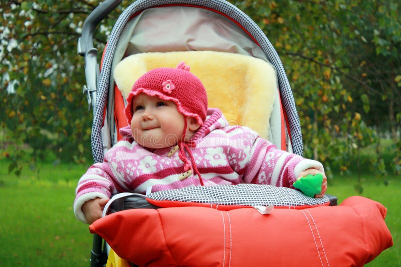 Baby in the stroller. Baby girl sitting in the stroller stock photography