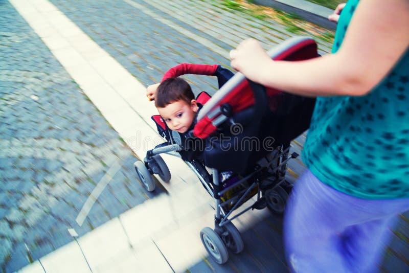 Baby in stroller. Looking back, motion blur stock photos
