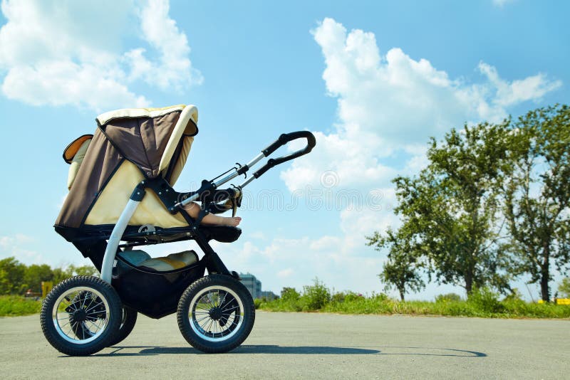 Baby stroller. On a walk in the park summer day stock photos
