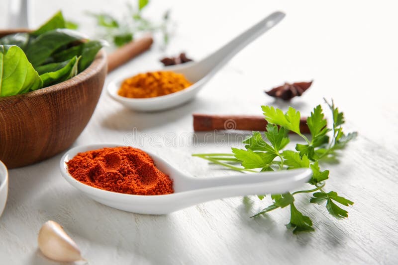 Composition with different spices and herbs on white wooden background royalty free stock image