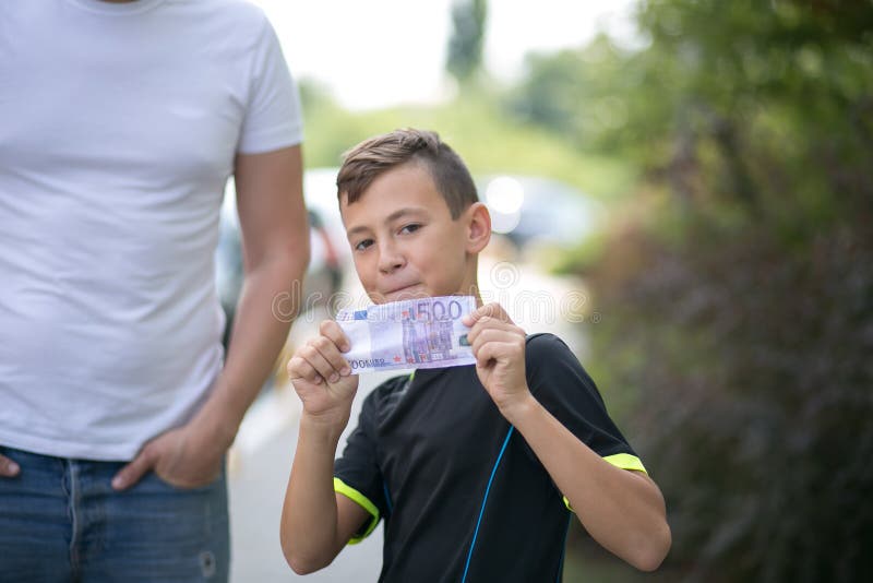 Cute teenager boy with money euro in hand.  royalty free stock image