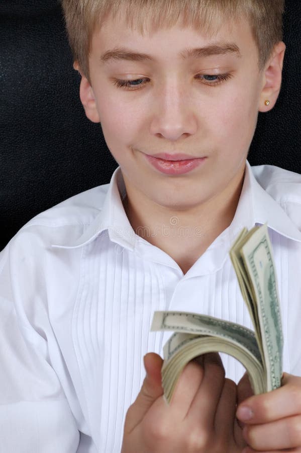 Dollars in hand at teenager. Teenager holds dollars in hand royalty free stock photo