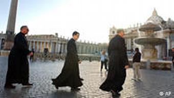 Three Catholic priests walk across St. Peter